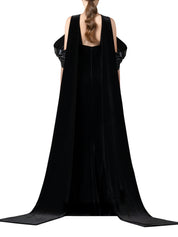 Halter-neck fitted velvet dress featuring a liquid gazar drape