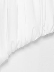Strapless long dress featuring voluminous draping at the hips