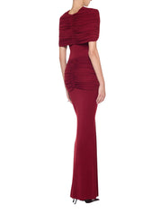 Form-fitting long dress featuring symmetrical draping at the bust and hips accented with a refined metal accessory