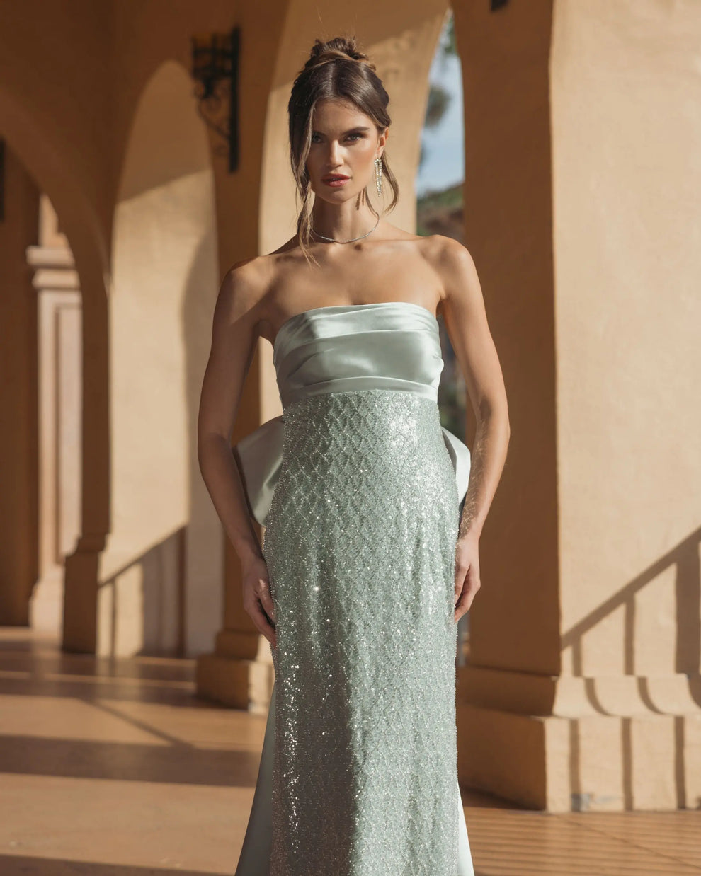 Green strapless embellished gown with back bow detail