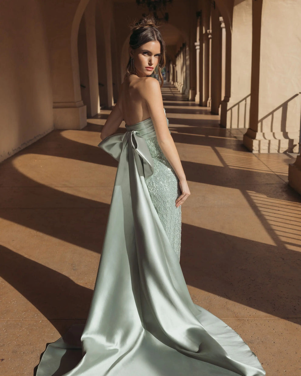 Green strapless embellished gown with back bow detail