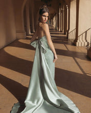 Green strapless embellished gown with back bow detail