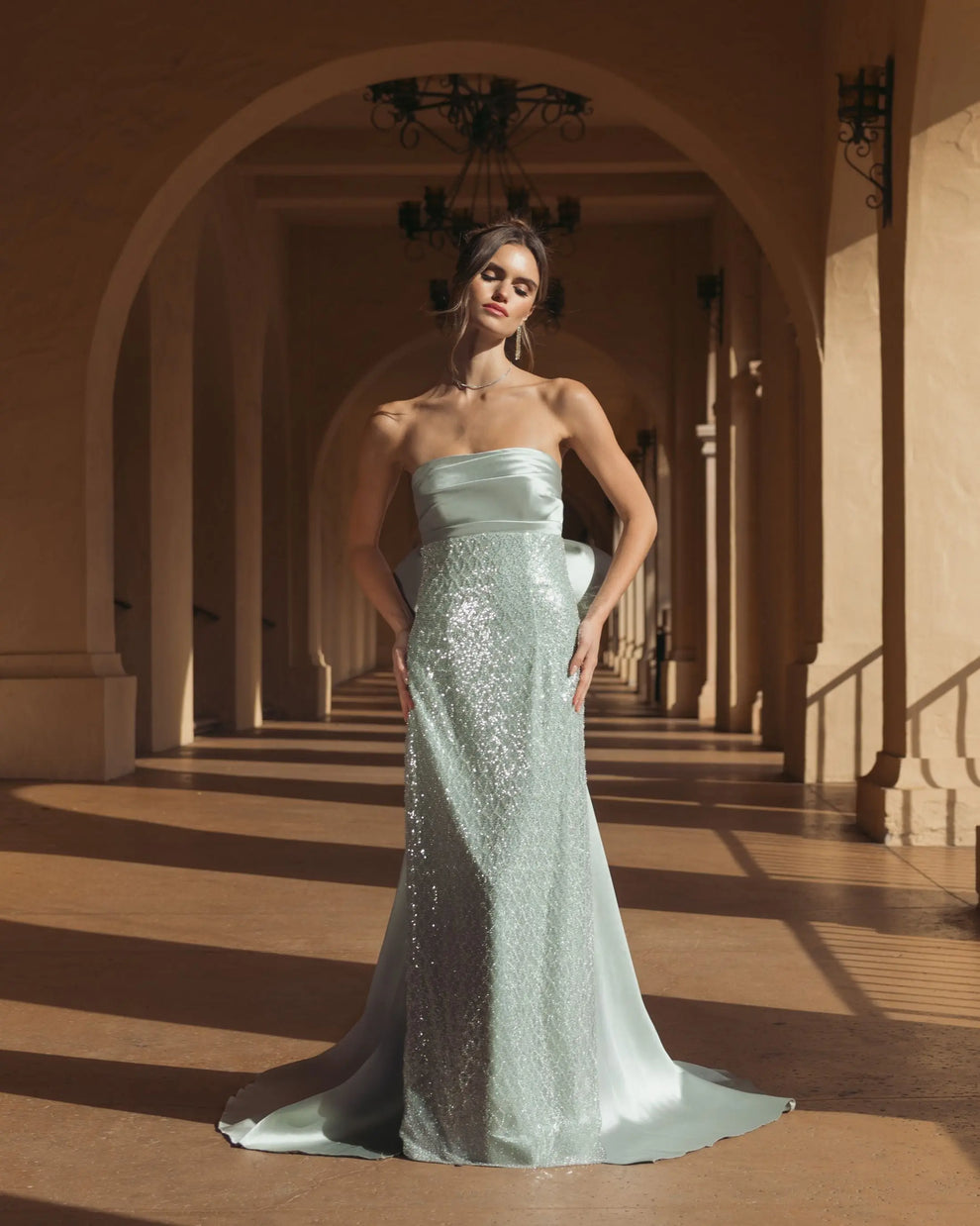 Green strapless embellished gown with back bow detail