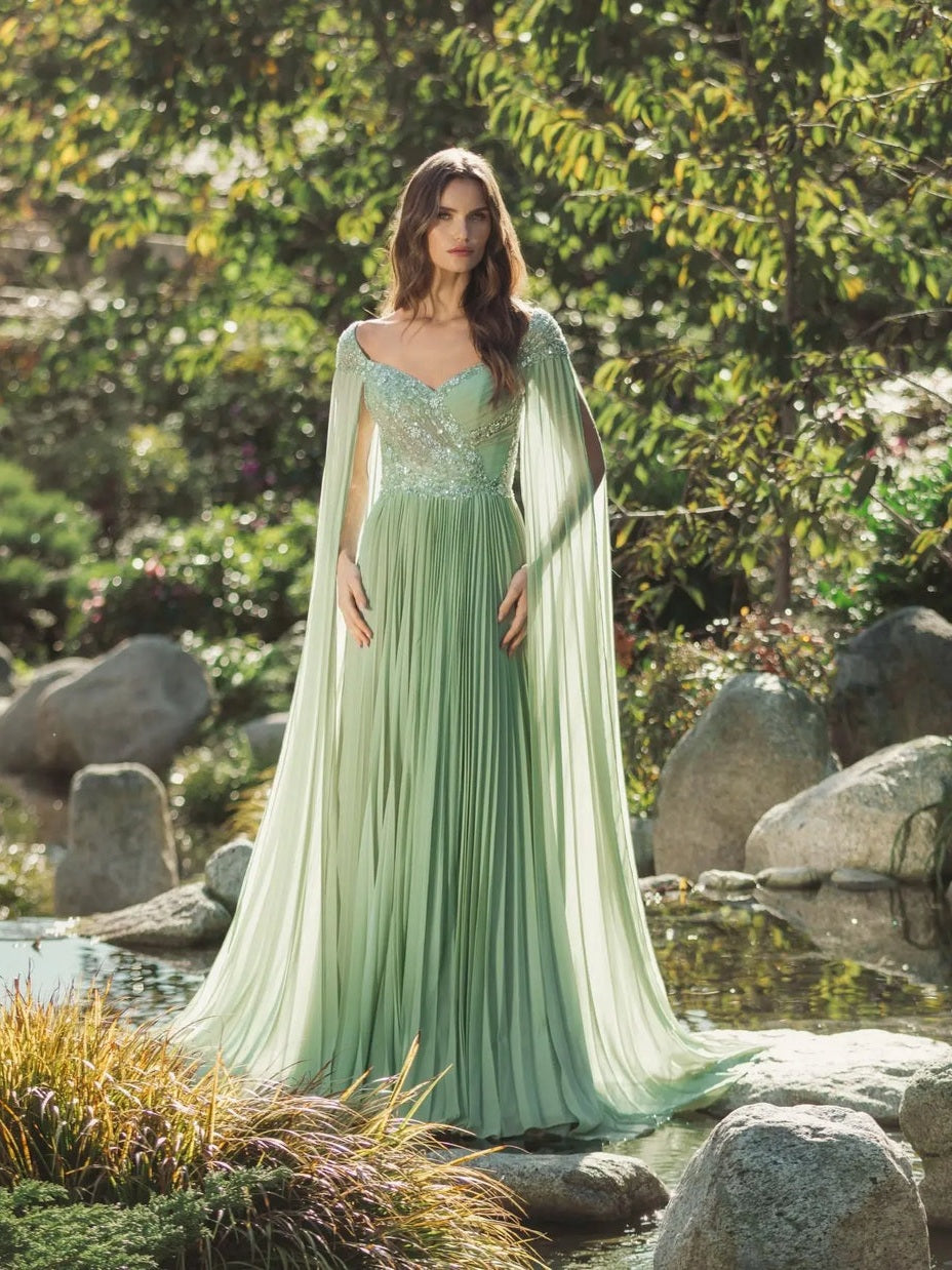 Green embellished chiffon cape sleeve a-line gown