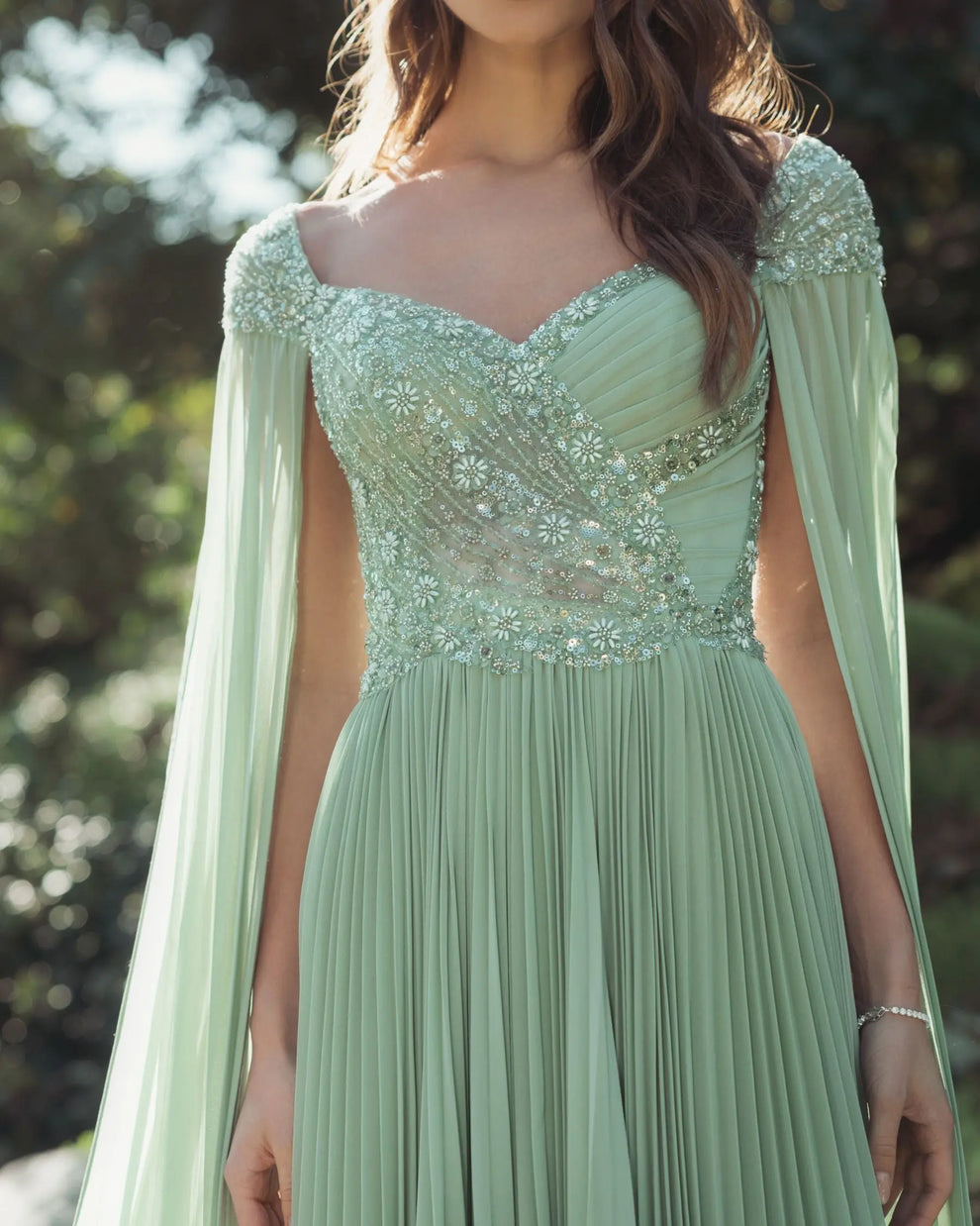 Green embellished chiffon cape sleeve a-line gown