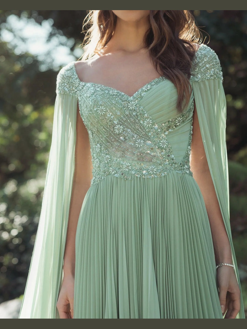 Green embellished chiffon cape sleeve a-line gown