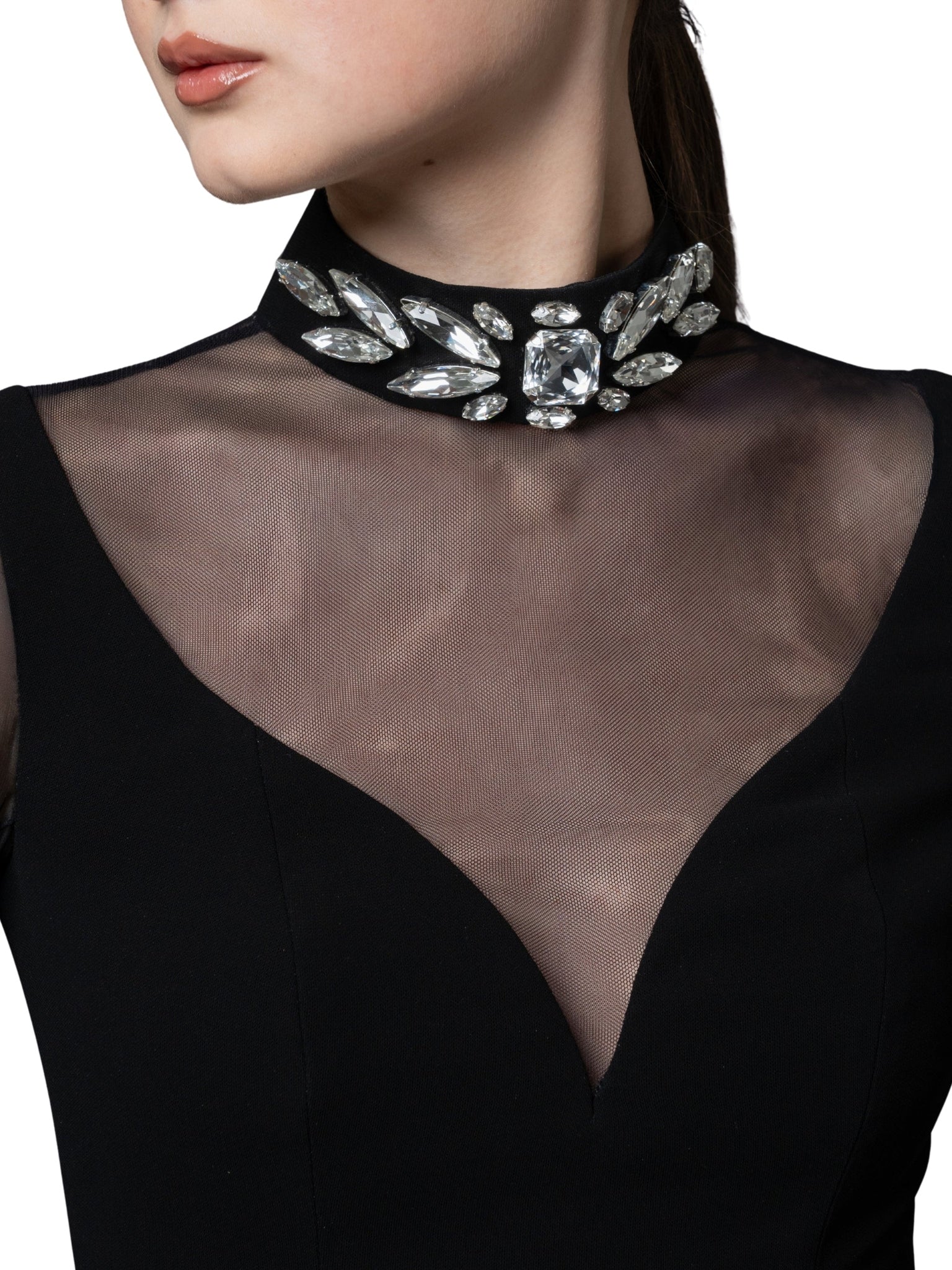 A high-neck gown featuring a crystal-embellished collar and cascading chiffon sleeves with chiffon godets that create a flowing movement.
