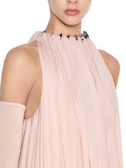 Voluminous halter top featuring a single-layer draped bodice accented with premium metal hardware details
