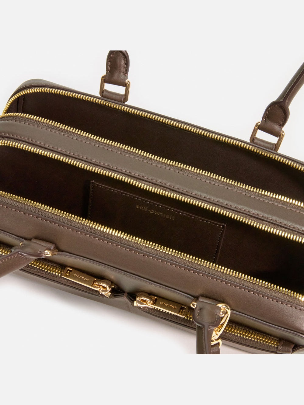 Brown leather baguette shoulder bag with charm